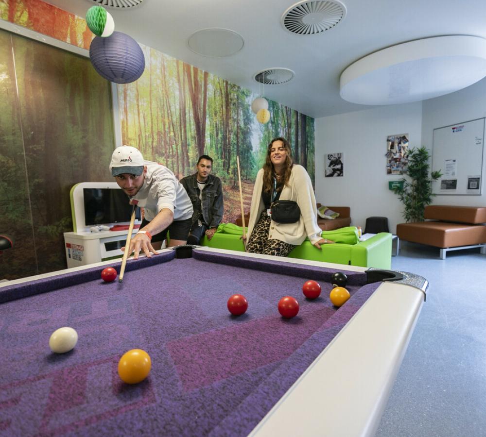 Young people playing pool on Teenage Cancer Trust unit