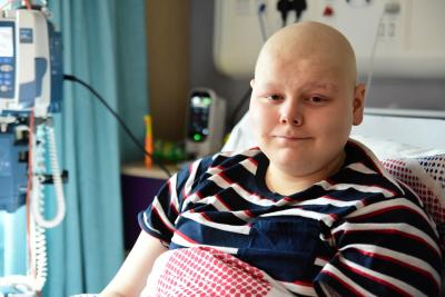 Teenage boy in hospital bed on Teenage Cancer Trust unit