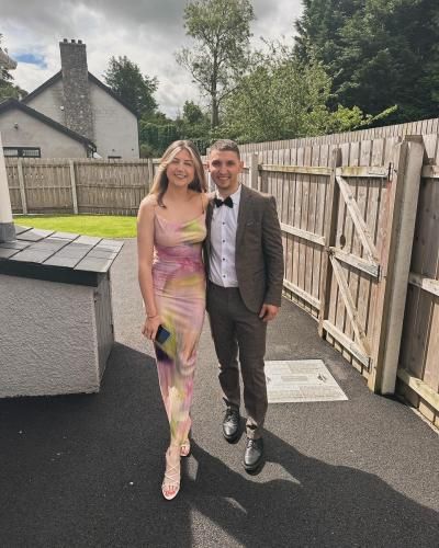 Clayton poses in a suit and bow-tie with his prom date