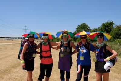 Participants smile wearing umbrella hats