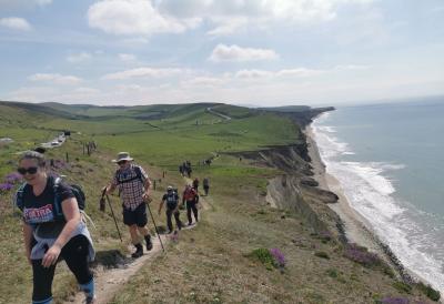 Participants trek along the coastal path