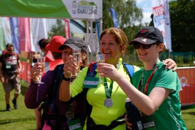 Participants celebrate with a glass of fizz at the finish line