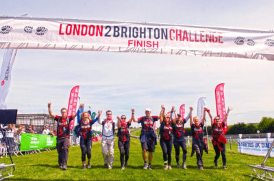 A team of participants cross the challenge finish line