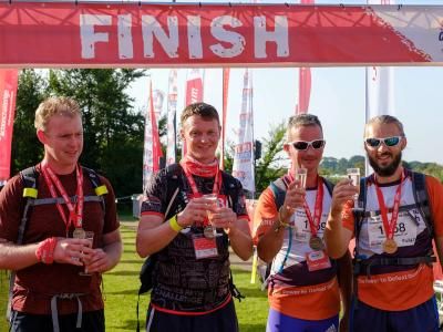 Participants celebrate with a glass of fizz at the finish line