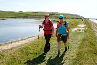 Participants trek by a lake