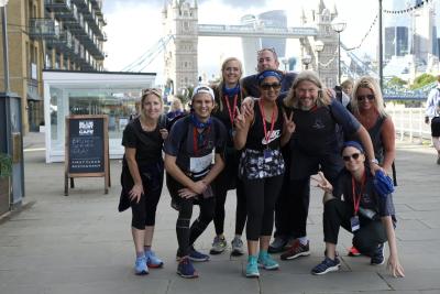 Participants smile in front of Tower Bridge