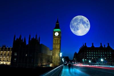 Big Ben next to a large moon