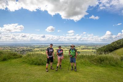 Participants smile with a view of the beautiful Kent Downs