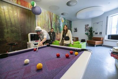 Young people playing pool on Teenage Cancer Trust unit