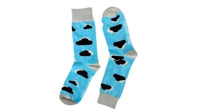 A pair of light blue socks with black clouds and silver linings